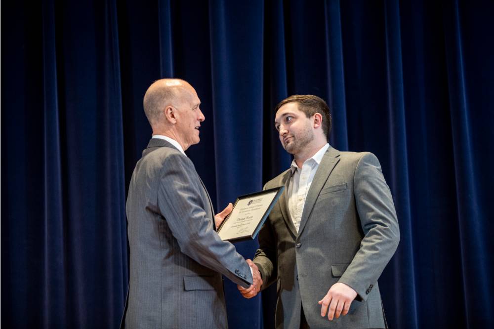 Dr. Potteiger (left) giving Tom Worm (right) his award.